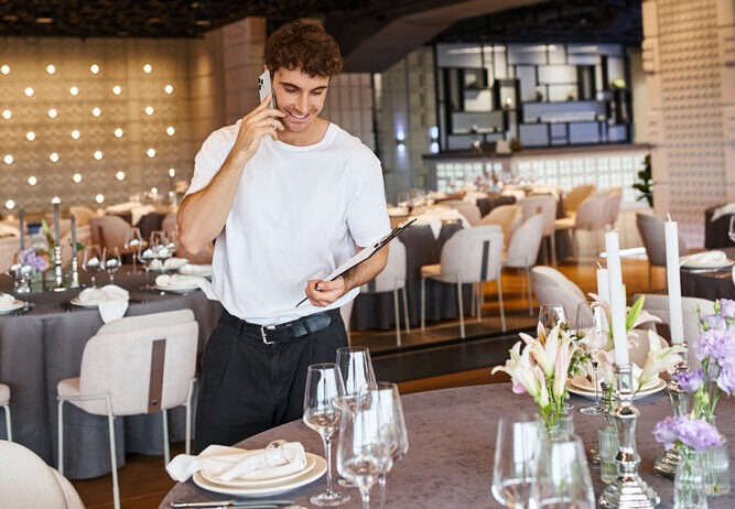 man setting up tables as event management